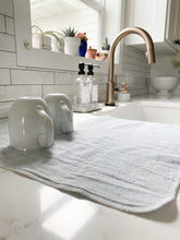Load image into Gallery viewer, Mugs drip drying on a handmade in the USA mist blue homespun linen dish drying mat, washable dish drying mat, oversized paperless towel, farmhouse kitchen, simple minimalist kitchen, natural fiber drying mat, beautiful simple kitchen accessories, woman owned small shop, small business, made in south dakota