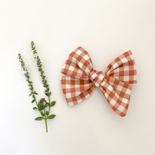 Load image into Gallery viewer, Rust Fall Floral Bows, Boho Fabric Bow Clips or Headbands, Classic Navy Pinwheel Set, Terracotta Gingham Check Bow, Copper Wildflower Bow, handmade fabric bows, boho style baby hair bows, burnt orange gingham check bow, navy floral hair bow, burnt orange floral vintage style hair bow, family pictures hair bow, school pictures hair bow, baby hair clips, handmade in the USA, made in the USA, stocking stuffer for girl, baby shower gift for girl, baby shower prize for girl