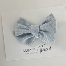 Load image into Gallery viewer, mist blue linen handmade pinwheel hair bow, light blue homespun linen baby bow on nylon hair clip or hair clip, sustainable small shop, eco-friendly hair bow, handamde in the USA, boho vintage modern small shop, women-owned small shop, classy classic modern kids clothes, handmade bow company, fabric bows