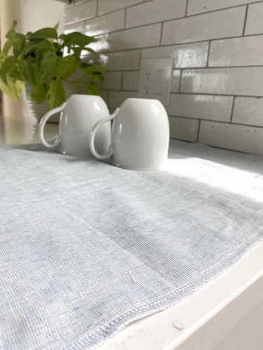 Mugs drip drying on a handmade in the USA mist blue homespun linen dish drying mat, washable dish drying mat, oversized paperless towel, farmhouse kitchen, simple minimalist kitchen, natural fiber drying mat, beautiful simple kitchen accessories, woman owned small shop, small business, made in south dakota