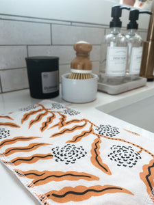 golden vine print handmade paperless towel displayed next to sink for eco-friendly homes and zero-waste families