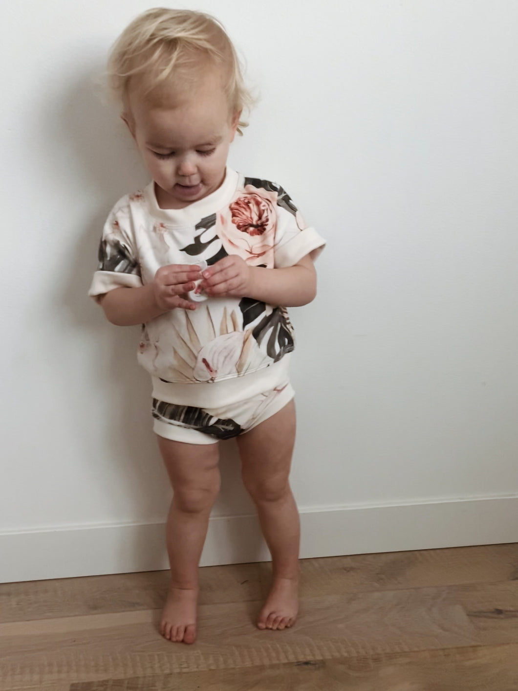 toddler girl wearing tropical boho print summer set includong handmade drop sleeve crop pullover and bummies with retro details