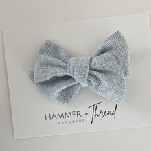 Load image into Gallery viewer, mist blue linen handmade pinwheel hair bow, light blue homespun linen baby bow on nylon hair clip or hair clip, sustainable small shop, eco-friendly hair bow, handamde in the USA, boho vintage modern small shop, women-owned small shop, classy classic modern kids clothes, handmade bow company, fabric bows
