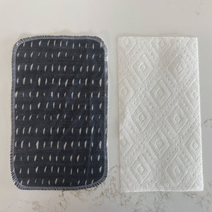 side by side compare dark gray reusable unpaper towel to paper towel